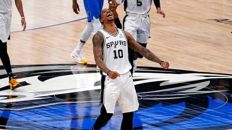 AP - San Antonio Spurs forward DeMar DeRozan, celebrates after sinking a basket in the final second 