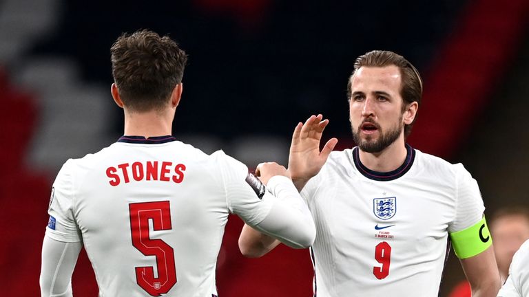 AP - Harry Kane congratulates John Stones after England's win over Poland