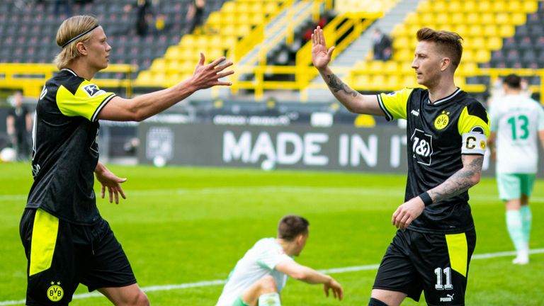 Haaland celebrates with Marco Reus during Dortmind's win