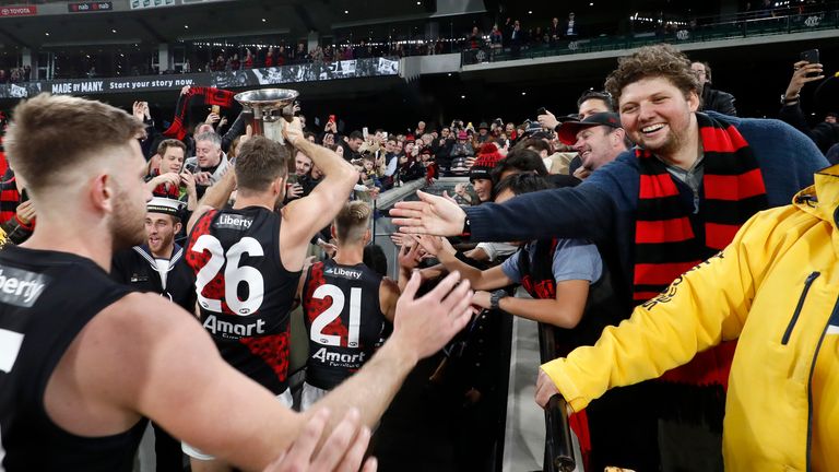 Essendon players celebrate their win after the round six AFL match between the Collingwood Magpies and the Essendon Bombers at Melbourne Cricket Ground on April 25, 2021 in Melbourne, Australia. (Photo by Darrian Traynor/AFL Photos/via Getty Images )