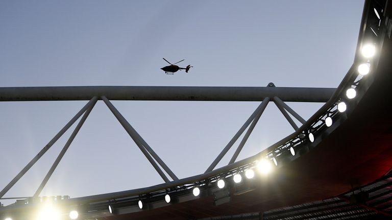 A helicopter hovers over the Emirates amid fan protest outside the ground