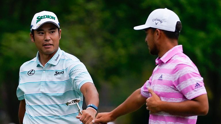 Hideki Matsuyama, of Japan, and Xander Schauffele, right, congratulate themselves after their eagles on the 15th hole during the third round of the Masters golf tournament on Saturday, April 10, 2021, in Augusta, Ga. (AP Photo/Matt Slocum)