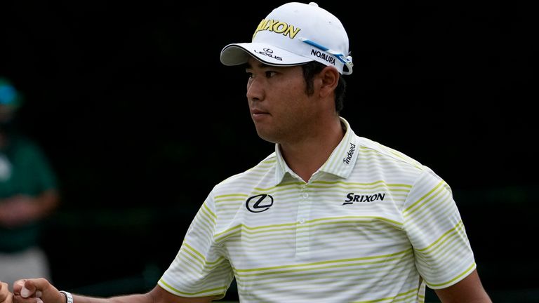 Hideki Matsuyama, of Japan, bumps fists with his caddie Shota Hayafuji after putting on the fifth hole during the final round of the Masters golf tournament on Sunday, April 11, 2021, in Augusta, Ga. (AP Photo/Gregory Bull)