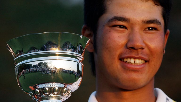 Hideki Matsuyama of Japan holds his trophy after winning the low amateur at the Masters golf tournament Sunday, April 10, 2011, in Augusta, Ga. (AP Photo/Charlie Riedel)