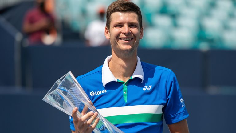 Poland's Hubert Hurkacz celebrates with the trophy after defeating Italy's Jannik Sinner in the men's finals match of the Miami Open tennis championship on Sunday, Apr. 4, 2021, in Miami Gardens, Fla. (Carlos Goldman/Miami Dolphins via AP)