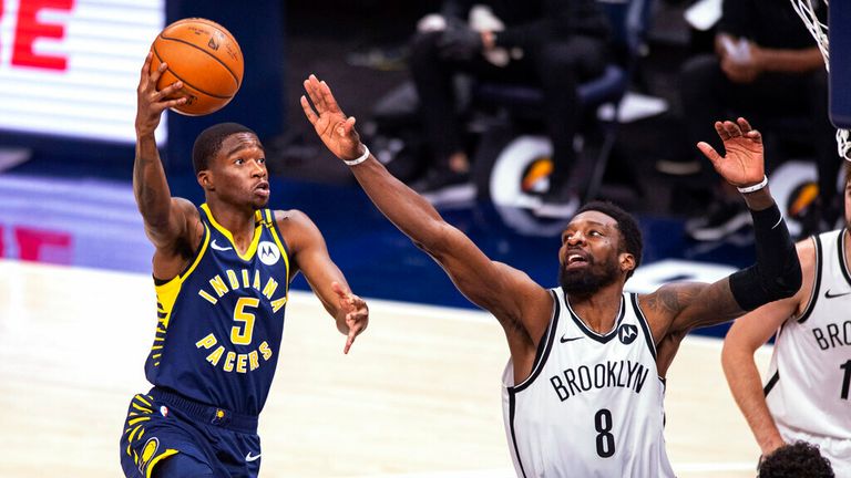 AP - Indiana Pacers guard Edmond Sumner (5) shoots around the defense of Brooklyn Nets forward Jeff Green (8)