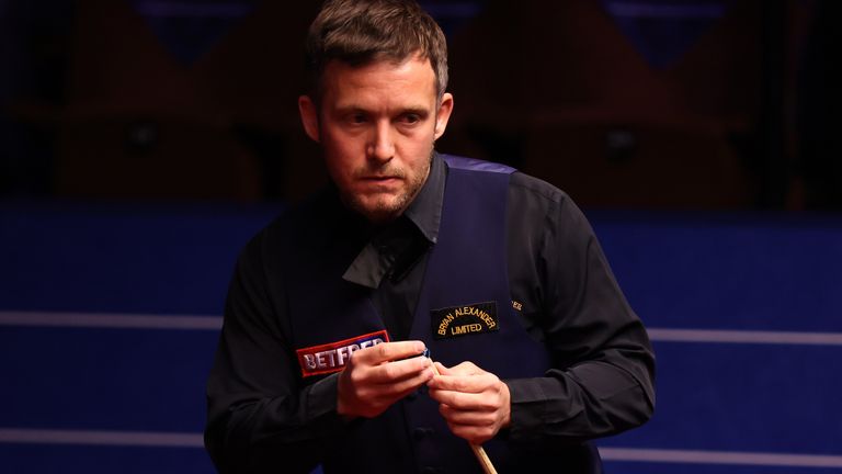 Jamie Jones of Wales chalks the cue during the Betfred World Snooker Championship Round One match between Jamie Jones of Wales and Stephen Maguire of Scotland at Crucible Theatre on April 18, 2021 in Sheffield, England. A maximum of 33% of the venue capacity will be in attendance as part of a Government pilot event. (Photo by George Wood/Getty Images)