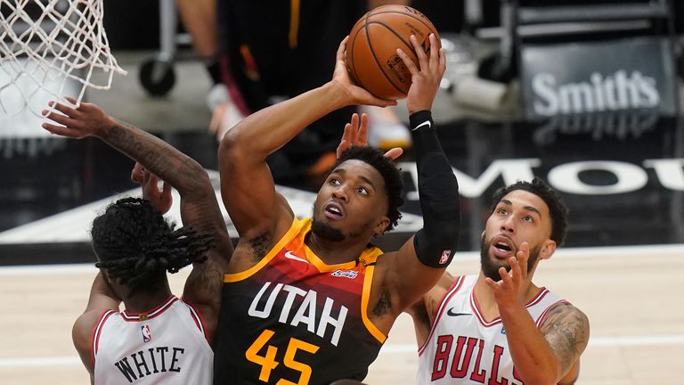 Utah Jazz guard Donovan Mitchell goes to the basket as Chicago Bulls&#39; Coby White and Denzel Valentine defend