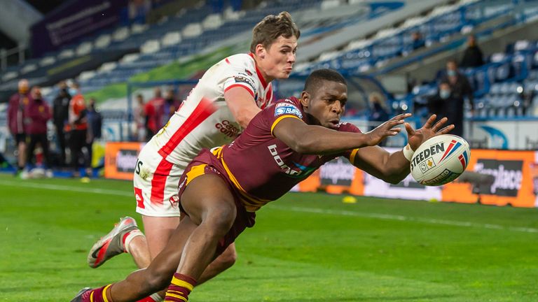 Jermaine McGillvary attempts to ground the ball to prevent St Helens's Jack Welsby scoring a try