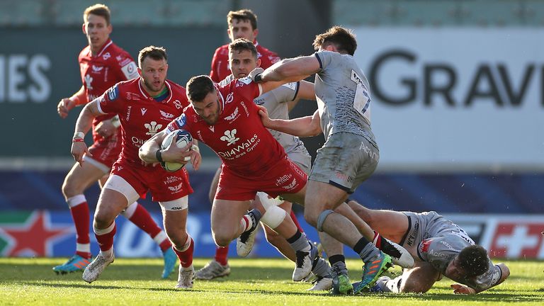 Scarlets' Johnny Williams is tackled by Sale Sharks' Tom Curry during the Heineken Champions Cup match at Parc y Scarlets, Llanelli. Picture date: Sunday April 4, 2021.