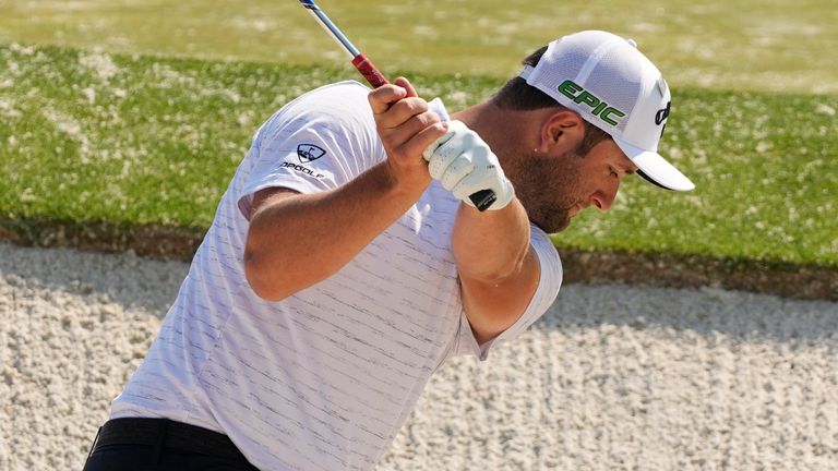 Jon Rahm, of Spain, hits out of a bunker at the driving range during a practice round for the Masters golf tournament on Wednesday, April 7, 2021, in Augusta, Ga. (AP Photo/Charlie Riedel)