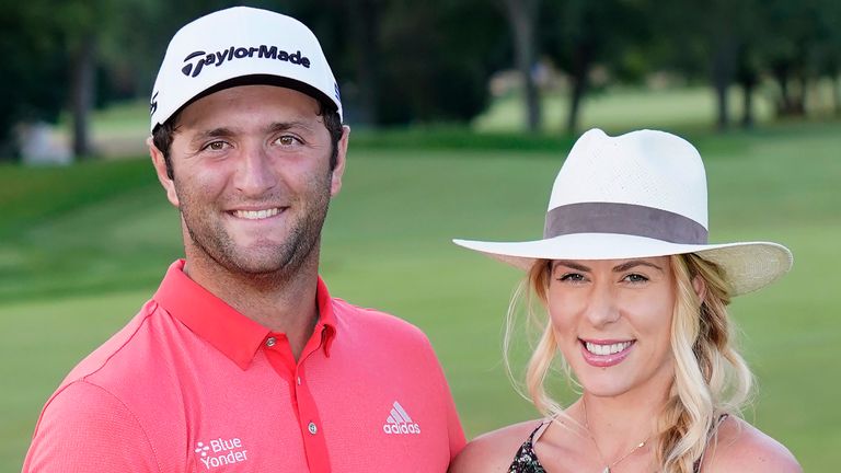 Jon Rahm, left, and his wife, Kelley Cahill, hold the BMW trophy while posing with the J.K. Wadley trophy after Rahm won the BMW Championship golf tournament at the Olympia Fields Country Club