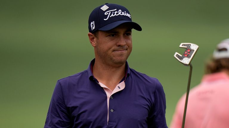 Justin Thomas holds up his putter after a birdie on the second hole during the final round of the Masters 