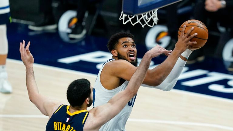 AP - Minnesota Timberwolves' Karl-Anthony Towns (32) is fouled by Indiana Pacers' Goga Bitadze (88)