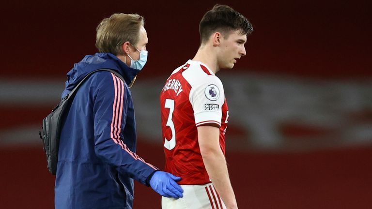 Kieran Tierney leaves the pitch after picking up an injury (AP)