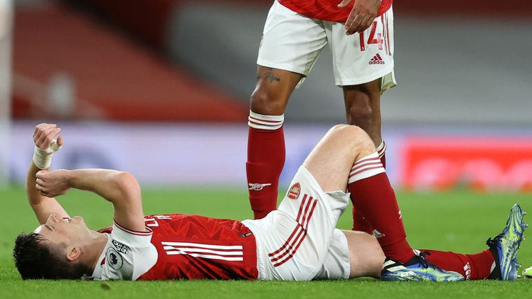 Kieran Tierney lies injured before receiving treatment on his left knee