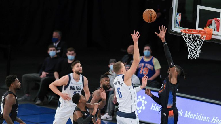 Dallas Mavericks center Kristaps Porzingis shoots over New York Knicks center Nerlens Noel 
