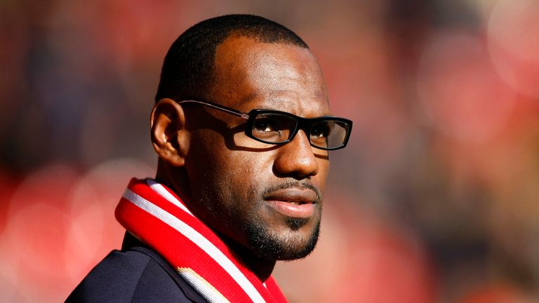 US and Miami Heat basketball player LeBron James looks on before the English Premier League soccer match between Liverpool and Manchester United at Anfield, Liverpool, England, Saturday Oct. 15, 2011.