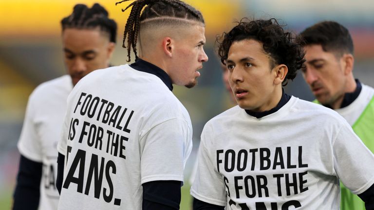 Kalvin Phillips of Leeds United warms up while wearing a protest t-shirt reading "Football is for the fans"