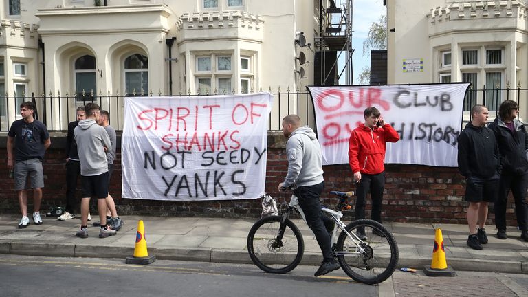Liverpool supporters hung banners outside Anfield on Saturday