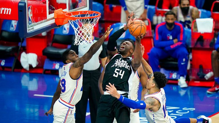 AP - Los Angeles Clippers' Patrick Patterson, center, tries to get a shot past Philadelphia 76ers' Shake Milton, left, and Danny Green