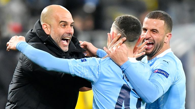 Manchester City's head coach Pep Guardiola celebrates with goal scorer Manchester City's Phil Foden during the Champions League quarterfinal second leg soccer match between Borussia Dortmund and Manchester City at the Signal Iduna Park stadium in Dortmund