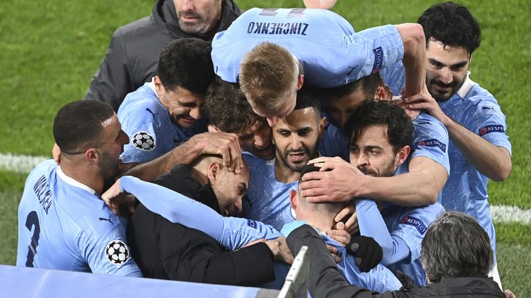 Manchester City manager Pep Guardiola celebrates with goal scorer Phil Foden and team-mates after their second goal during the UEFA Champions League, quarter final, second leg match at Signal Iduna Park in Dortmund