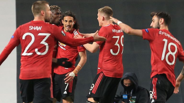 Man Utd players celebrate Edinson Cavani putting them ahead against Roma