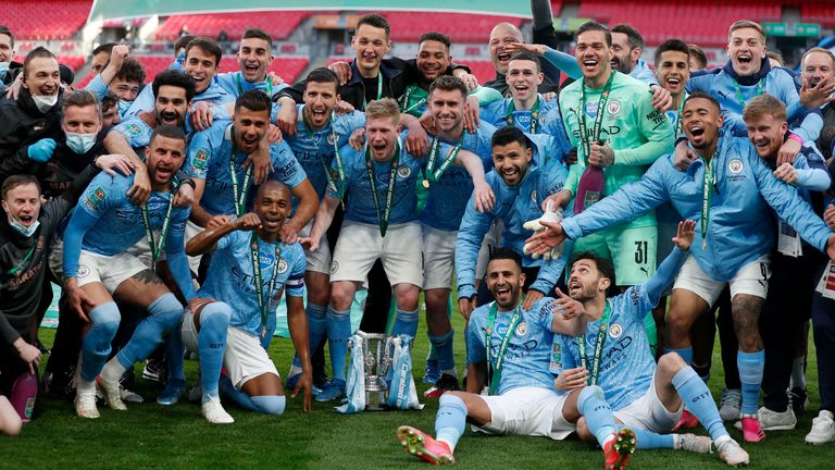 Manchester City players celebrate with the trophy after defeating Spurs 1-0 in the Carabao Cup final (AP)