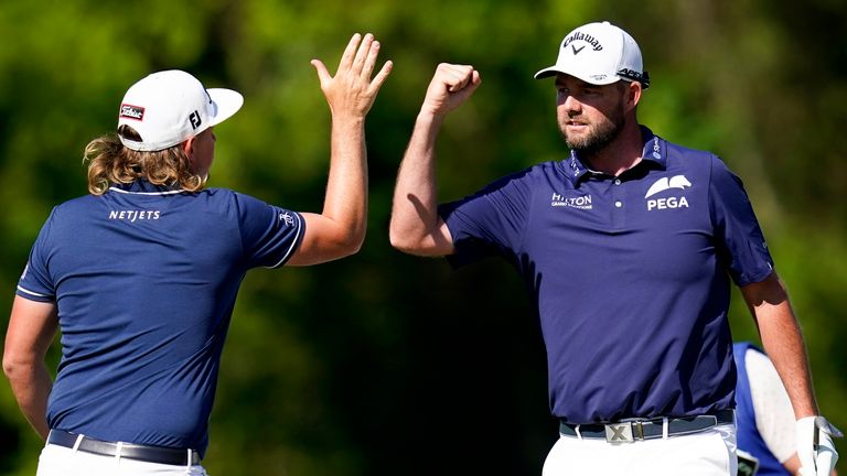 Marc Leishman, of Australia, celebrates with teammate Cameron Smith, of Australia, left, after making a putt on the 16th green during the final round of the PGA Zurich Classic 