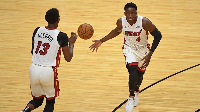 Victor Oladipo hands off to Bam Adebayo for the Miami Heat