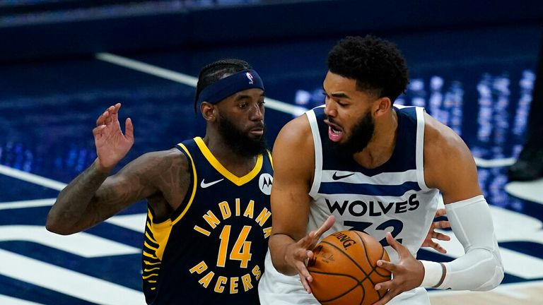 AP - Minnesota Timberwolves&#39; Karl-Anthony Towns (32) is defended by Indiana Pacers&#39; JaKarr Sampson (14)
