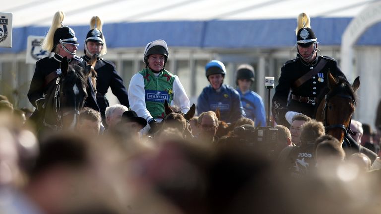 Barry Geraghty is led into the winner enclosure after winning the Grand National on Monty's Pass in 2003