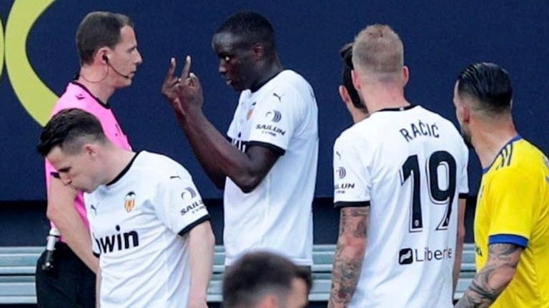 Valencia's Mouctar Diakhaby speaks to the referee following an alleged racist insult from Cadiz defender Juan Cala (unseen)
