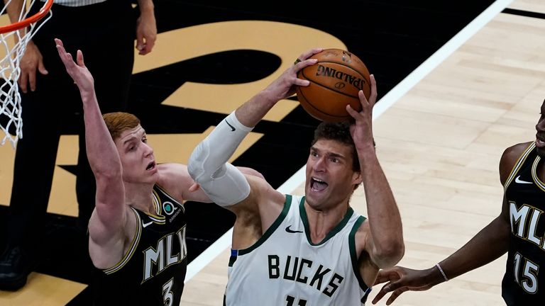 Milwaukee Bucks center Brook Lopez (11) works against Atlanta Hawks guard Kevin Huerter (3 in the first half of an NBA basketball game Thursday, April 15, 2021, in Atlanta. (AP Photo/John Bazemore)


