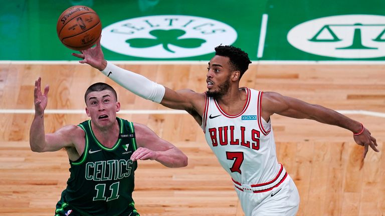 Chicago Bulls forward Troy Brown Jr., left, grabs a rebound over Boston Celtics guard Payton Pritchard, right, during the first half of an NBA basketball game, Monday, April 19, 2021, in Boston. (AP Photo/Charles Krupa) 