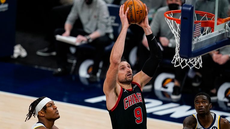Chicago Bulls center Nikola Vucevic (9) gets a dunk over Indiana Pacers guard Edmond Sumner (5) during the second half of an NBA basketball game in Indianapolis, Tuesday, April 6, 2021.