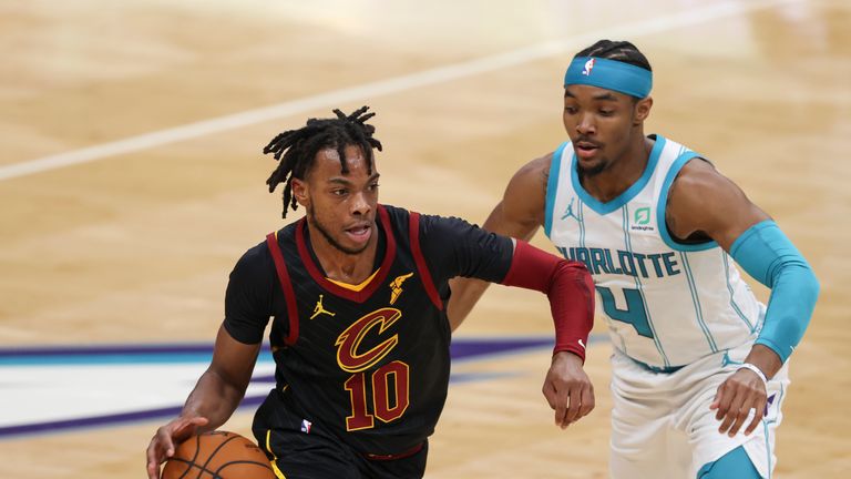 Cleveland Cavaliers guard Darius Garland, left, drives against Charlotte Hornets guard Devonte&#39; Graham in the first half of an NBA basketball game in Charlotte, N.C., Wednesday, April 14, 2021. Cleveland won 103-90. (AP Photo/Nell Redmond)