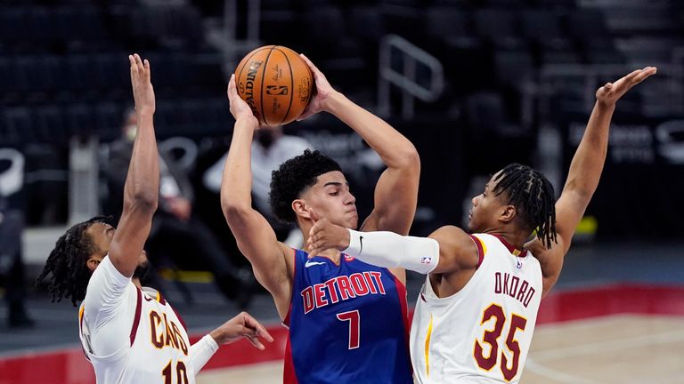 Detroit Pistons guard Killian Hayes (7) looks to pass as Cleveland Cavaliers guard Darius Garland (10) and forward Isaac Okoro (35) defend during the second half of an NBA basketball game, Monday, April 19, 2021, in Detroit. (AP Photo/Carlos Osorio) 