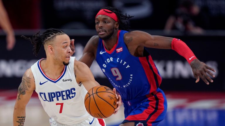 Los Angeles Clippers guard Amir Coffey (7) looks back to Detroit Pistons forward Jerami Grant (9) during the first half of an NBA basketball game, Wednesday, April 14, 2021, in Detroit. (AP Photo/Carlos Osorio)



