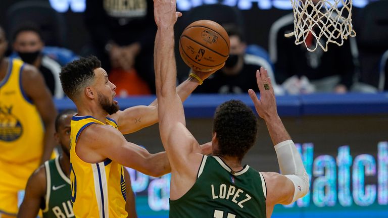 Golden State Warriors guard Stephen Curry, left, shoots against Milwaukee Bucks center Brook Lopez (11) during the first half of an NBA basketball game in San Francisco, Tuesday, April 6, 2021.