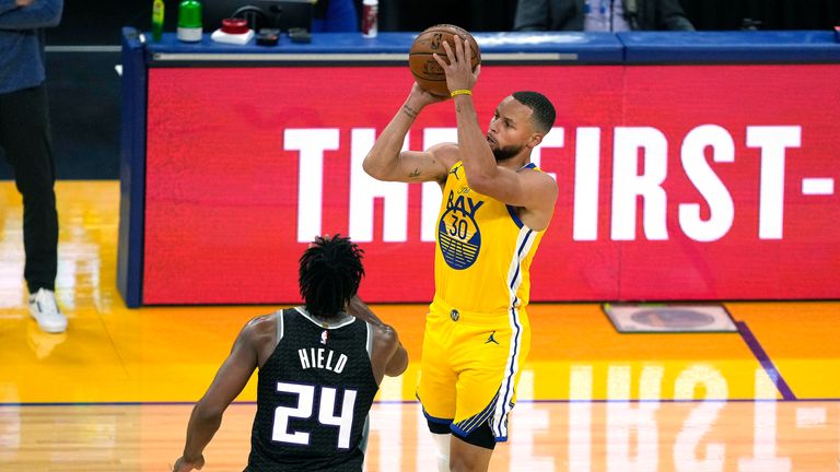 Golden State Warriors guard Stephen Curry (30) takes a 3-point shot over Sacramento Kings guard Buddy Hield (24) during the first half of an NBA basketball game on Sunday, April 25, 2021, in San Francisco. (AP Photo/Tony Avelar)


