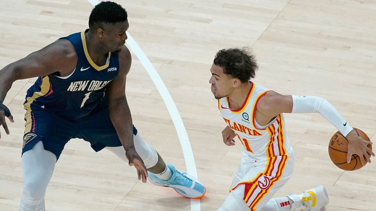 Atlanta Hawks guard Trae Young (11) works against New Orleans Pelicans forward Zion Williamson (1) in the first half of an NBA basketball game Tuesday, April 6, 2021, in Atlanta.