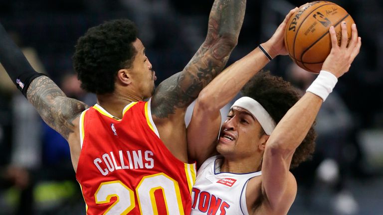 Detroit Pistons guard Frank Jackson, right, collides with Atlanta Hawks forward John Collins, left, while going to the basket during the fourth quarter of an NBA basketball game Monday, April 26, 2021, in Detroit. 