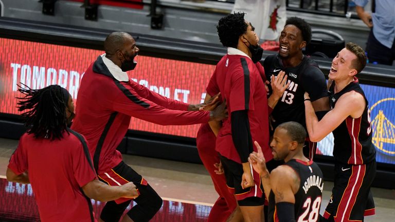 Miami Heat center Bam Adebayo (13) is mobbed by teammates after he made the winning shot against the Brooklyn Nets at the end of an NBA basketball game, Sunday, April 18, 2021, in Miami. (AP Photo/Wilfredo Lee)


