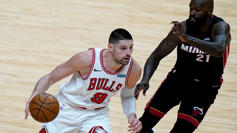 Chicago Bulls center Nikola Vucevic (9) drives to the basket as Miami Heat center Dewayne Dedmon (21) defends during the second half of an NBA basketball game, Monday, April 26, 2021, in Miami. (