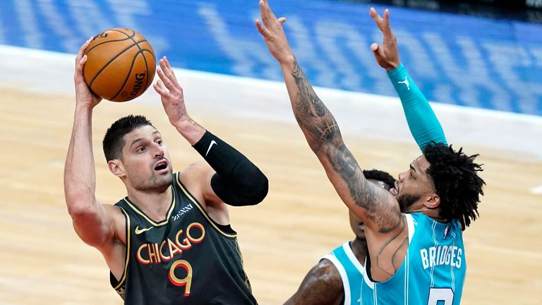Chicago Bulls&#39; Nikola Vucevic (9) shoots over Charlotte Hornets&#39; Miles Bridges during the first half of an NBA basketball game Thursday, April 22, 2021, in Chicago.
