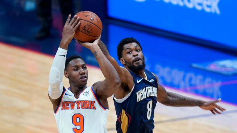 New York Knicks guard RJ Barrett (9) shoots under pressure from New Orleans Pelicans forward Naji Marshall (8) in the first half of an NBA basketball game in New Orleans, Wednesday, April 14, 2021. (AP Photo/Gerald Herbert)