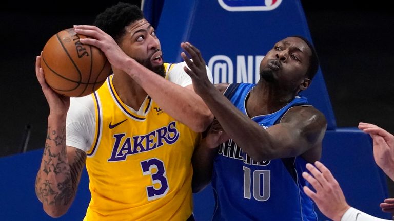 Los Angeles Lakers&#39; Anthony Davis (3) works against Dallas Mavericks&#39; Dorian Finney-Smith (10) and Luka Doncic, right, for a shot in the first half of an NBA basketball game in Dallas, Thursday, April 22, 2021.