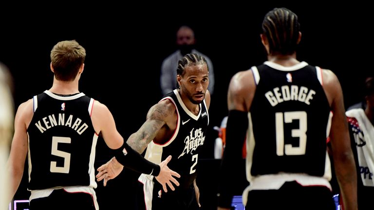 LOS ANGELES, CA - APRIL 4: Kawhi Leonard #2 of the LA Clippers high-fives teammates during the game against the Los Angeles Lakers on April 4, 2021 at STAPLES Center in Los Angeles, California. NOTE TO USER: User expressly acknowledges and agrees that, by downloading and/or using this Photograph, user is consenting to the terms and conditions of the Getty Images License Agreement. Mandatory Copyright Notice: Copyright 2021 NBAE (Photo by Adam Pantozzi/NBAE via Getty Images) 